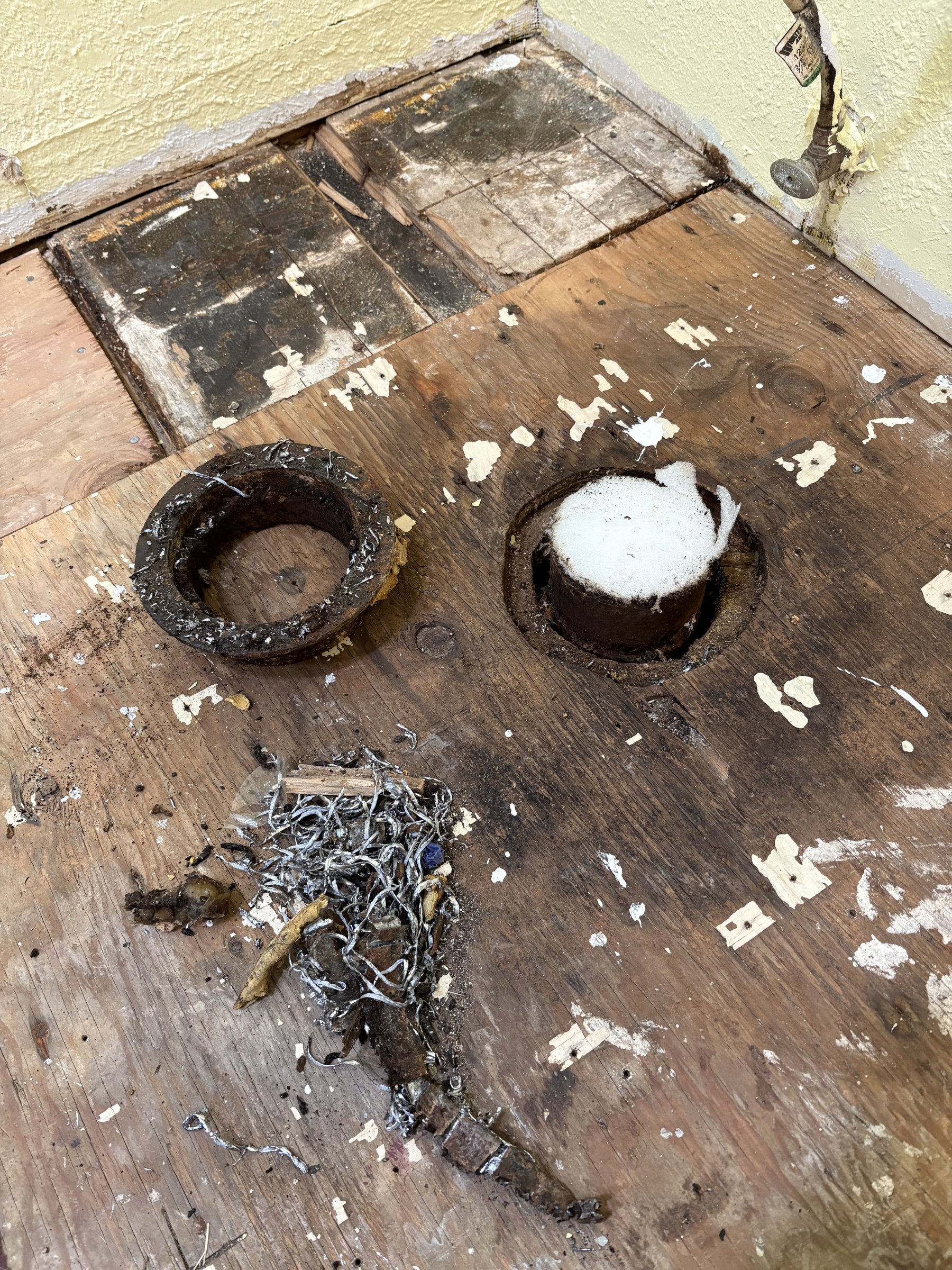 Damaged cast-iron toilet flange before CPR Handyman repair