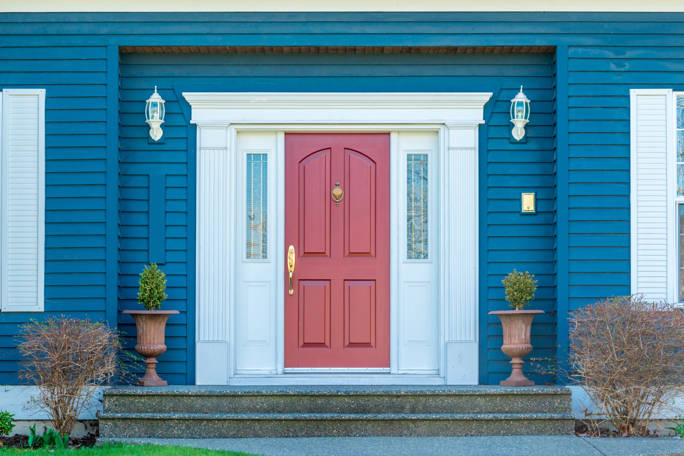 Welcoming red front door on a blue home